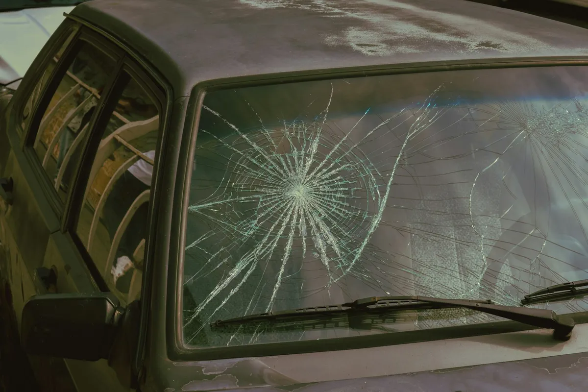 Windshield with a large spiderweb crack that needs replacing